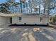 Front exterior showcasing new landscaping, and a long concrete driveway at 5520 Morning Creek Cir, Atlanta, GA 30349