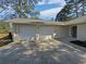 Exterior elevation showcasing a two car garage and a landscaped front yard at 5520 Morning Creek Cir, Atlanta, GA 30349