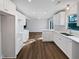 Open kitchen with white cabinets, stainless appliances, and wood flooring at 5520 Morning Creek Cir, Atlanta, GA 30349