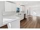 Well-lit kitchen featuring white countertops and cabinetry with hardwood flooring at 5520 Morning Creek Cir, Atlanta, GA 30349