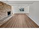 Bright, airy living room with hardwood floors, a beautiful fireplace, ceiling fan, and freshly painted white walls at 5520 Morning Creek Cir, Atlanta, GA 30349