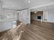 Spacious living area with wood floors, white cabinets and brick fireplace at 5520 Morning Creek Cir, Atlanta, GA 30349