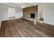 Spacious living room featuring a brick fireplace, wood floors, and ample natural light at 5520 Morning Creek Cir, Atlanta, GA 30349