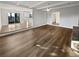 An open living room with wood flooring, leading into the kitchen and dining area at 5520 Morning Creek Cir, Atlanta, GA 30349