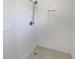 Tiled shower featuring grey tiled flooring, a shower head and a built in shower caddy at 5520 Morning Creek Cir, Atlanta, GA 30349