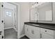 Clean bathroom design with white cabinets, black hardware, and a glass-enclosed shower at 837 Lakemont Dr, Canton, GA 30114