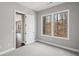 Comfortable bedroom bathed in natural light, showcasing hardwood floors and views of the lush outdoor landscape at 837 Lakemont Dr, Canton, GA 30114