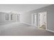 Large room with neutral carpet, several doors and windows, and gray walls at 837 Lakemont Dr, Canton, GA 30114