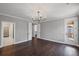 Spacious bedroom with hardwood floors, modern lighting, and neutral gray paint at 837 Lakemont Dr, Canton, GA 30114