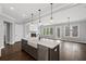 Open-concept kitchen with a farmhouse sink, stainless steel appliances, and a view into the living room at 837 Lakemont Dr, Canton, GA 30114