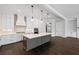 Bright kitchen features a large island, designer lighting, and access to living area at 837 Lakemont Dr, Canton, GA 30114