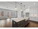 Modern kitchen featuring an island with seating, a farmhouse sink, and a seamless flow to an outdoor living space at 837 Lakemont Dr, Canton, GA 30114