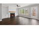Bright living room with hardwood floors, fireplace, and large windows showcasing a scenic outdoor view at 837 Lakemont Dr, Canton, GA 30114