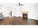 Inviting living room featuring hardwood floors, a cozy fireplace, and custom built-in shelving at 837 Lakemont Dr, Canton, GA 30114