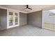 Relaxing covered patio with ceiling fan and gray wood-look flooring is perfect for outdoor living at 837 Lakemont Dr, Canton, GA 30114