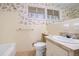 Bathroom with yellow tile, floral wallpaper, and single vanity at 2124 Azalea Cir, Decatur, GA 30033