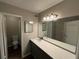 This bathroom features a large mirror, single vanity, and a toilet room at 2992 Parc Lorraine, Lithonia, GA 30038