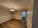 Cozy dining room with modern chandelier and hardwood flooring at 2992 Parc Lorraine, Lithonia, GA 30038