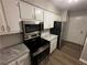 A well-equipped kitchen with stainless steel appliances and bright white cabinets at 2992 Parc Lorraine, Lithonia, GA 30038