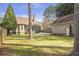 A cozy screened-in porch overlooks a private backyard, enhanced by mature trees and a fenced perimeter at 3207 Kensington Rd, Avondale Estates, GA 30002