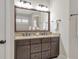 Bathroom with granite countertops, a dark vanity, and an oversized mirror at 3207 Kensington Rd, Avondale Estates, GA 30002