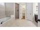 Spacious bathroom with a soaking tub, shower, dual closets, and tile flooring at 3207 Kensington Rd, Avondale Estates, GA 30002