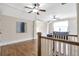 Open-concept bonus room with hardwood floors, ceiling fans, and access to multiple rooms at 3207 Kensington Rd, Avondale Estates, GA 30002
