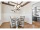 Elegant dining room with coffered ceiling, wainscoting, and chandelier lighting at 3207 Kensington Rd, Avondale Estates, GA 30002