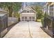View of detached two-car garage, long driveway, and fenced yard at 3207 Kensington Rd, Avondale Estates, GA 30002