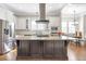 Well-lit kitchen with stainless appliances, white cabinets and a dark wood kitchen island at 3207 Kensington Rd, Avondale Estates, GA 30002