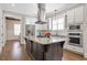 Bright kitchen offers stainless appliances, white cabinets, and granite counters on the island at 3207 Kensington Rd, Avondale Estates, GA 30002