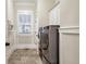 Well-organized laundry room featuring a front-load washer and dryer and tile flooring at 3207 Kensington Rd, Avondale Estates, GA 30002