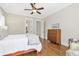 Main bedroom with hardwood floors, ceiling fan, a view into the ensuite and walk-in closet at 3207 Kensington Rd, Avondale Estates, GA 30002