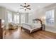 Bright main bedroom with hardwood floors, a ceiling fan, and large windows with plantation shutters at 3207 Kensington Rd, Avondale Estates, GA 30002