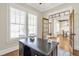Sunlit office featuring a dark wood desk, plantation shutters, and French doors at 3207 Kensington Rd, Avondale Estates, GA 30002