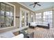 Inviting sunroom with large windows, comfortable seating, and wood flooring at 3207 Kensington Rd, Avondale Estates, GA 30002