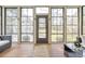 Enclosed sunroom with multiple windows, stylish furniture and a wooden floor at 3207 Kensington Rd, Avondale Estates, GA 30002
