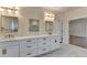 Stylish bathroom featuring a double vanity, framed mirrors, and modern lighting fixtures at 5533 Addison Woods Pl, Buford, GA 30518