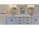Bright bathroom featuring a double vanity, marble countertops, and modern lighting at 5533 Addison Woods Pl, Buford, GA 30518