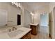 Bathroom featuring double vanity with stone countertop and wood cabinets at 5533 Addison Woods Pl, Buford, GA 30518