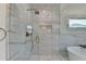 Bathroom shower features marble tile, a glass door, and modern gold fixtures at 5533 Addison Woods Pl, Buford, GA 30518