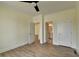 Bedroom with luxury vinyl floors, white trim, and open doorways for bathroom and closet access at 5533 Addison Woods Pl, Buford, GA 30518