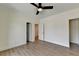 Bedroom featuring laminate flooring, a ceiling fan, and access to other rooms at 5533 Addison Woods Pl, Buford, GA 30518