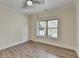 Cozy bedroom featuring a large window with backyard views and neutral paint at 5533 Addison Woods Pl, Buford, GA 30518