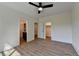 Bedroom featuring luxury vinyl floors, white trim, and open doorways for bathroom and closet access at 5533 Addison Woods Pl, Buford, GA 30518