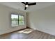 Bedroom with hardwood floors, large window and neutral colored walls at 5533 Addison Woods Pl, Buford, GA 30518