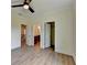 Bedroom featuring ceiling fan, wood floors, with ensuite bathroom and closet at 5533 Addison Woods Pl, Buford, GA 30518