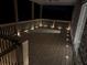 Outdoor deck enhanced with ambient lighting, creating a cozy and inviting atmosphere for evening gatherings at 5533 Addison Woods Pl, Buford, GA 30518