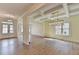 Spacious dining area with wood floors, coffered ceiling, and modern lighting at 5533 Addison Woods Pl, Buford, GA 30518