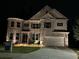 Beautiful two-story home with brick facade and well-manicured lawn, showcasing an inviting curb appeal at 5533 Addison Woods Pl, Buford, GA 30518